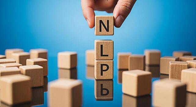 Hand placing wooden blocks spelling NLP on a reflective surface against a blue background representing Neuro Linguistic Programming and the power of communication for personal development and success photo