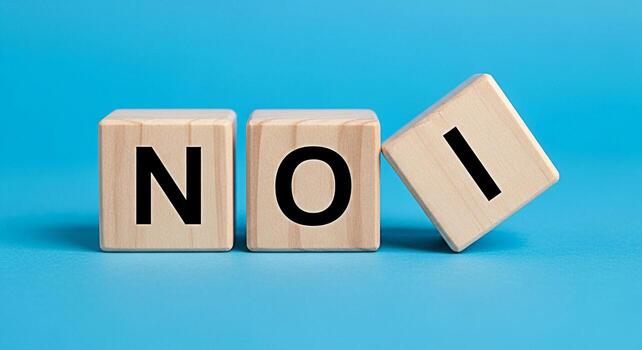 Wooden blocks spelling NOI on a blue surface conveying a sense of rejection and negativity suitable for illustrating concepts of denial disagreement or refusal in a clear and concise manner photo