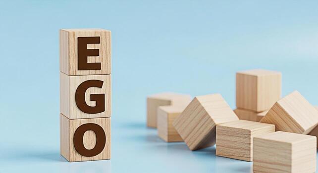 apilado de madera bloques ortografía ego en un azul superficie representando egocentrismo y inflado autoestima con dispersado bloques simbolizando fragilidad y desequilibrio en un minimalista estudio ajuste foto