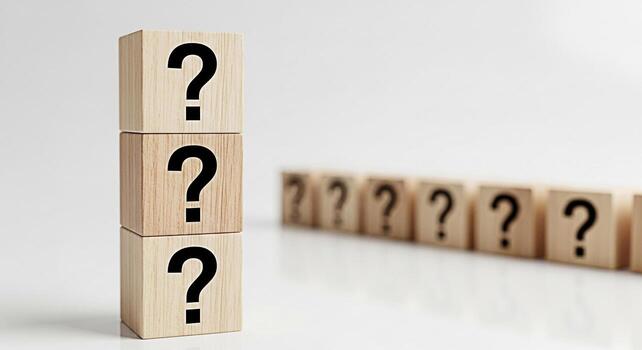 Stack of wooden blocks displaying question marks on a clean white surface symbolizing uncertainty and the quest for answers in business and personal life fostering curiosity and problemsolving photo
