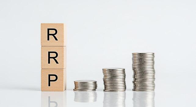 Wooden blocks spelling RRP next to stacks of coins on a white surface representing the concept of Retail Recommended Price and financial growth in a clean minimalist setting conveying stability and in photo
