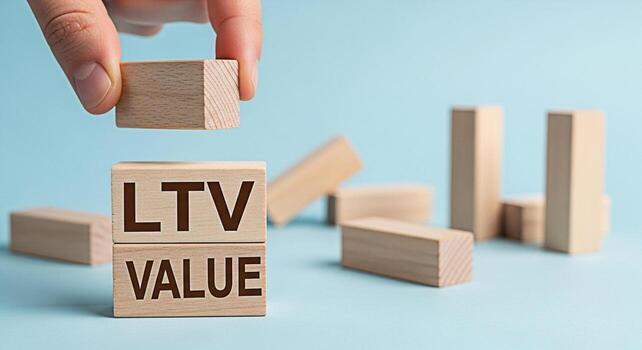 Hand placing a wooden block on top of LTV VALUE blocks in a bright minimalist setting symbolizing customer lifetime value and business growth with a focus on longterm profitability and strategic inves photo