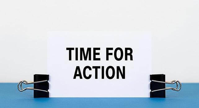 Bold Time for Action message displayed on a white card held by binder clips against a clean white backdrop conveying urgency and a call to immediate progress and positive change in a business setting photo