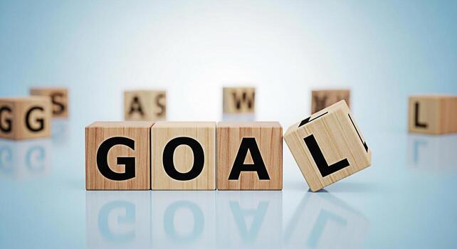 Wooden blocks spelling GOAL on a reflective surface with other blocks scattered in the background symbolizing ambition achievement and the pursuit of success in a bright and optimistic setting photo