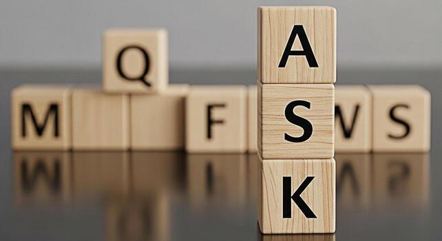 Wooden blocks spelling ASK standing prominently on a reflective surface amidst other blurred lettered blocks symbolizing inquiry and problemsolving in a business or educational environment fostering c photo
