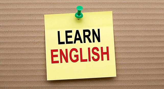 amarillo pegajoso Nota con el palabras aprender Inglés adjunto a un cartulina superficie con un verde empujar alfiler promoviendo idioma educación y habilidad desarrollo en un sencillo directo y visualmente atractivo camino foto