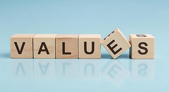 Wooden blocks spelling VALUES on a light blue surface highlighting the importance of core principles and ethics in a business environment conveying a sense of integrity and trust photo