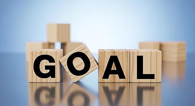 Wooden blocks spelling GOAL on a reflective surface symbolizing ambition and achievement in a business setting conveying a sense of determination and focus towards success and reaching targets photo