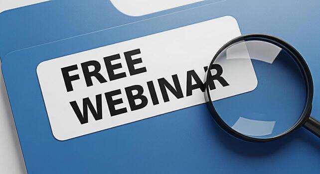 Closeup of a blue file folder displaying Free Webinar under a magnifying glass symbolizing opportunity and education in a professional setting highlighting the concept of accessible online learning an photo