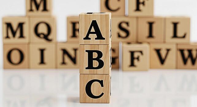 Stack of wooden alphabet blocks displaying ABC in a bright studio setting symbolizing early childhood education learning the basics and fostering a playful educational environment for children photo