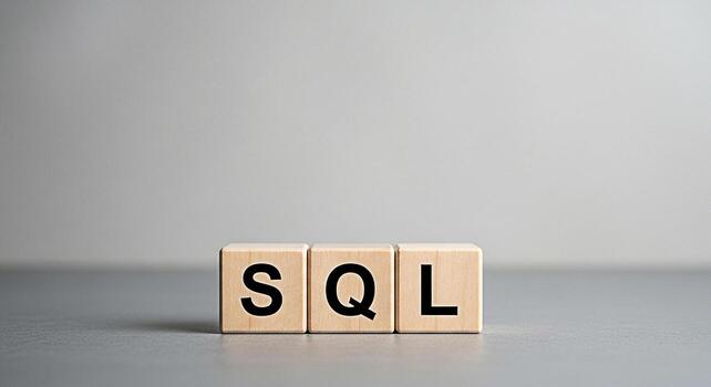 Wooden blocks displaying SQL on a gray surface representing database query language in a minimalist studio setting conveying a concept of data management and structured information retrieval photo