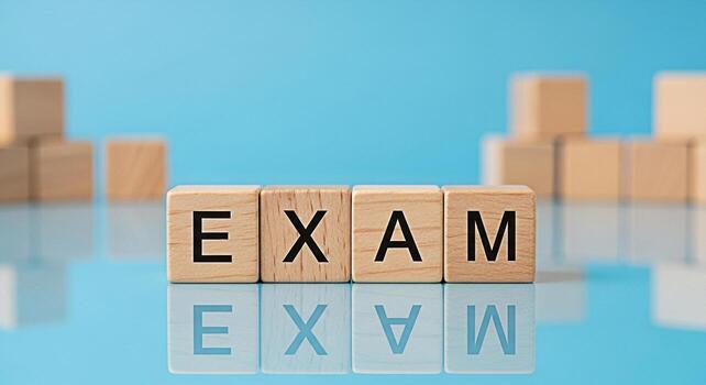 Wooden blocks spelling EXAM on a reflective surface against a blue background representing the concept of academic testing and the pressure of performance in a learning environment photo