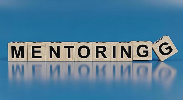Wooden blocks spelling MENTORING on a reflective surface against a blue background symbolizing guidance support and the importance of mentorship in personal and professional development photo