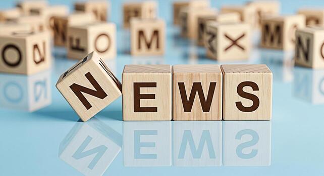 Wooden blocks spelling NEWS on a reflective blue surface conveying a sense of information and current events in a clean and modern setting suitable for news media and communication concepts photo