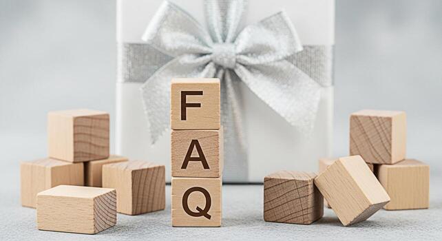 Wooden blocks spelling FAQ displayed in a bright studio setting with a gift box representing frequently asked questions and providing answers creating a sense of clarity and support for customers photo