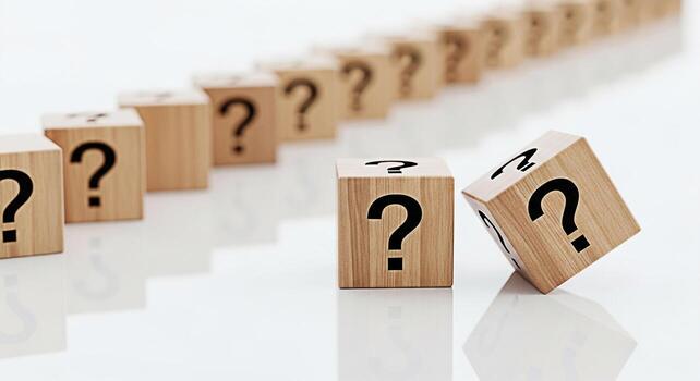 Wooden cubes displaying question marks in a bright studio setting representing uncertainty problemsolving and the search for answers in business education and personal development contexts photo
