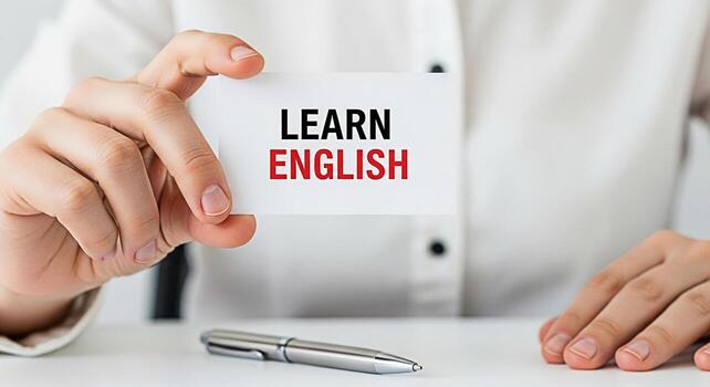 de cerca de un persona participación un tarjeta ese dice aprender Inglés en un blanco escritorio con un bolígrafo simbolizando educación idioma adquisición y el búsqueda de conocimiento en un profesional ajuste foto