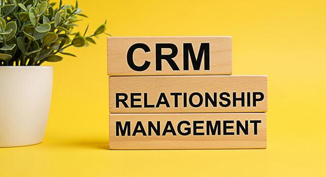 Wooden blocks displaying CRM Relationship Management on a bright yellow background symbolizing effective customer relations and business strategy for growth and success in a modern business environmen photo