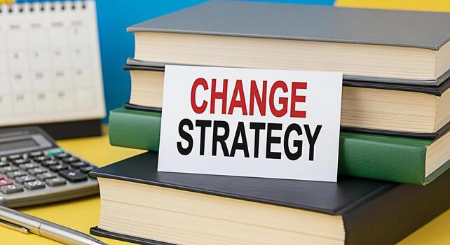 Closeup of a Change Strategy card resting on a stack of books in a bright organized workspace symbolizing planning and adaptation for business success and highlighting the importance of strategic thin photo