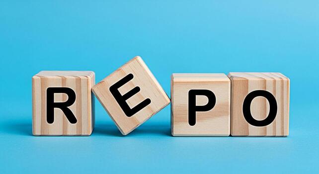 Wooden blocks spelling out REPO on a blue surface representing repurchase agreement and financial transactions conveying concepts of finance banking and investment in a clean minimalist setting photo