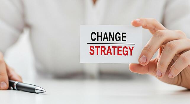 Closeup of a business person holding a card with the words Change Strategy in a bright office setting symbolizing adaptation and planning for future success in a dynamic business environment photo