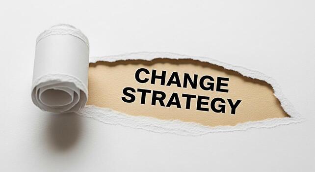 Torn white paper revealing the words Change Strategy on a beige background symbolizing a shift in business approach and the need for adaptation in a dynamic and competitive market environment photo