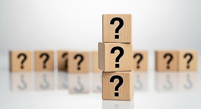 Stacked wooden blocks displaying question marks in a bright studio setting representing uncertainty problemsolving and the search for answers in business and personal life photo