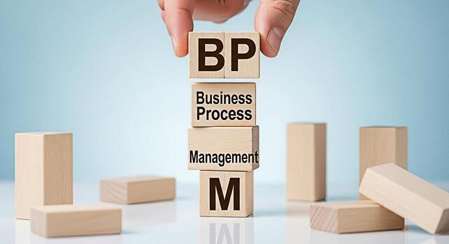 Hand stacking wooden blocks displaying BPM Business Process Management on a reflective surface against a light blue background representing efficiency and strategic business solutions photo