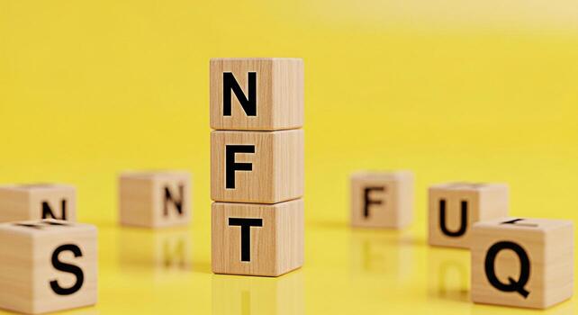 Wooden blocks spelling NFT stacked on a yellow surface representing digital assets and blockchain technology creating a modern and innovative atmosphere for cryptocurrency and investment concepts photo