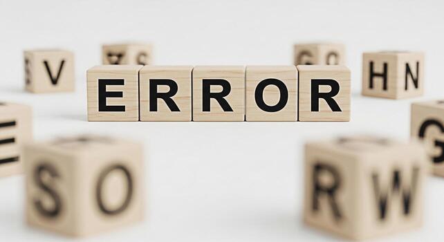 Wooden blocks spelling out ERROR on a white surface surrounded by other lettered blocks symbolizing a system failure technical problem or programming bug in a clean minimalist setting photo