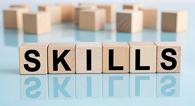 Wooden blocks spelling SKILLS on a reflective blue surface representing learning and development highlighting the importance of acquiring new skills for career advancement and personal growth in a com photo