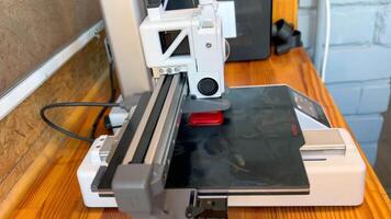 3d printer creating two red handles layer by layer video