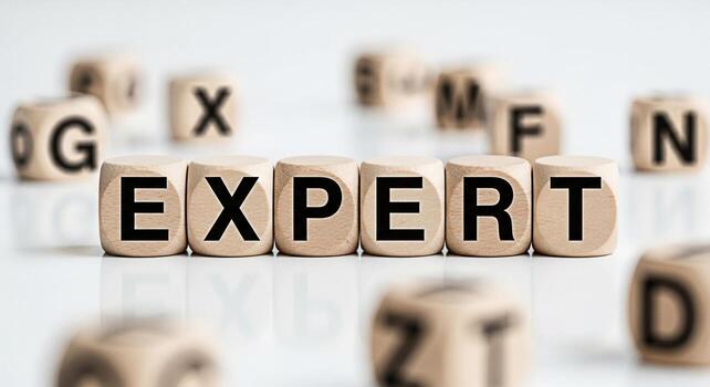 Wooden cubes spelling EXPERT on a white surface symbolizing knowledge and skill conveying a message of competence and professionalism in a clean and minimalist setting ideal for business and education photo