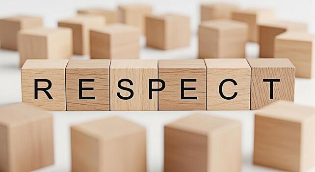Wooden blocks spelling RESPECT arranged on a white surface symbolizing the importance of respect in building strong relationships and fostering a positive environment promoting values of kindness and photo