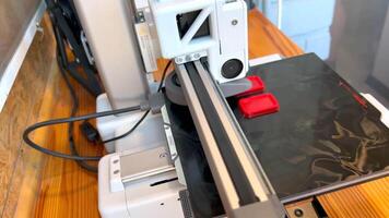 3d printer creating a red plastic object layer by layer video
