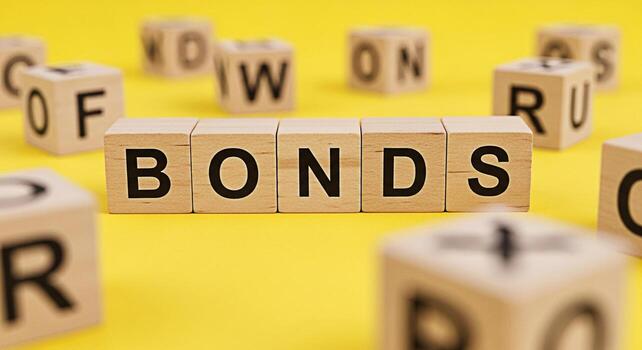 Wooden blocks spelling out WORDS and FUN on a bright yellow background creating a playful and educational atmosphere perfect for illustrating language learning word games and creative expression photo