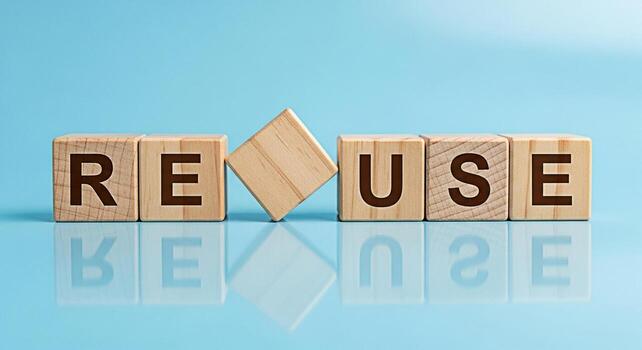 Wooden blocks spelling REUSE on a reflective blue surface promoting environmental awareness and sustainable practices symbolizing responsibility and a commitment to ecofriendly living for a greener fu photo