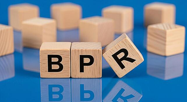 Arrangement of wooden blocks on a blue surface creating a minimalist cityscape symbolizing growth stability and the building blocks of success in a clean and modern aesthetic photo