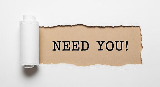 Urgent message Need You revealed through torn white paper creating a sense of immediate requirement and opportunity in a minimalist studio setting emphasizing recruitment and call to action photo