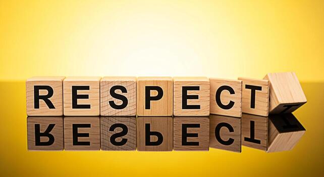 Wooden blocks spelling RESPECT on a yellow background symbolizing the importance of respect in relationships and society promoting values of consideration dignity and ethical behavior in a bright and photo