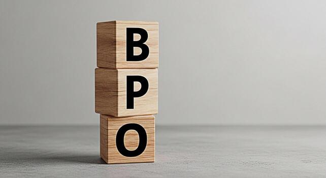 Stacked wooden blocks displaying BPO on a neutral surface representing business process outsourcing efficiency and strategic partnerships in a minimalist and modern setting with a focus on clarity and photo