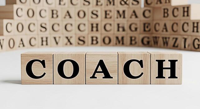 Wooden blocks spelling COACH on a white surface representing guidance and support in a learning environment fostering personal and professional development with a motivational and encouraging atmosphe photo