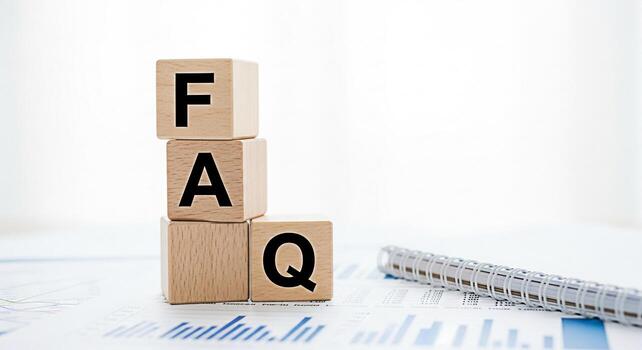 Wooden blocks spelling FAQ resting on a financial report in a bright office representing frequently asked questions and information accessibility for business and customer support conveying clarity an photo