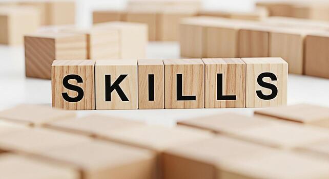 Wooden blocks spelling SKILLS on a clean white surface surrounded by other blocks representing the concept of acquiring new skills learning and professional development in a bright and minimalist sett photo