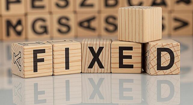 Wooden blocks spelling FIXED resting on a reflective surface with blurred background blocks symbolizing problemsolving solutions and the successful resolution of issues with a sense of accomplishment photo