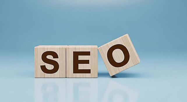 Wooden blocks spelling SEO on a light blue surface representing search engine optimization strategies and digital marketing techniques for improved online visibility and website ranking success photo