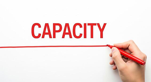 Hand underlining the word CAPACITY on a white background with a red marker symbolizing potential limit ability and the importance of understanding constraints in business and personal growth represent photo