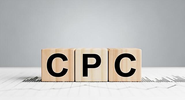 Wooden blocks displaying CPC on a financial chart symbolizing cost per click advertising strategy in a neutraltoned setting conveying a message of effective online marketing and budget management photo