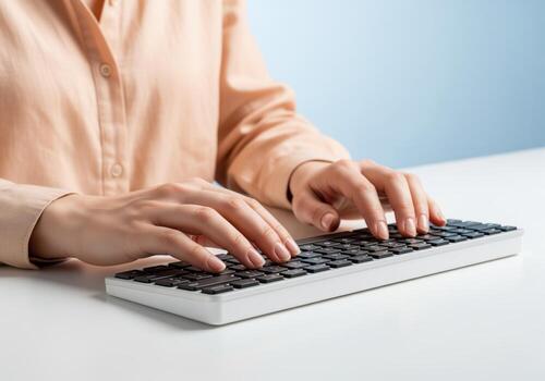 Woman hands typing on a modern white keyboard for office work or data entry photo