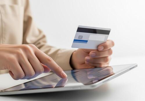 Close up of hands performing secure online payment using credit card and digital tablet photo